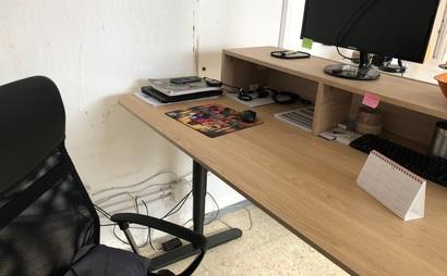 Sit/stand desk in 4-person shared workspace Sit/stand desk in 4-person shared workspace