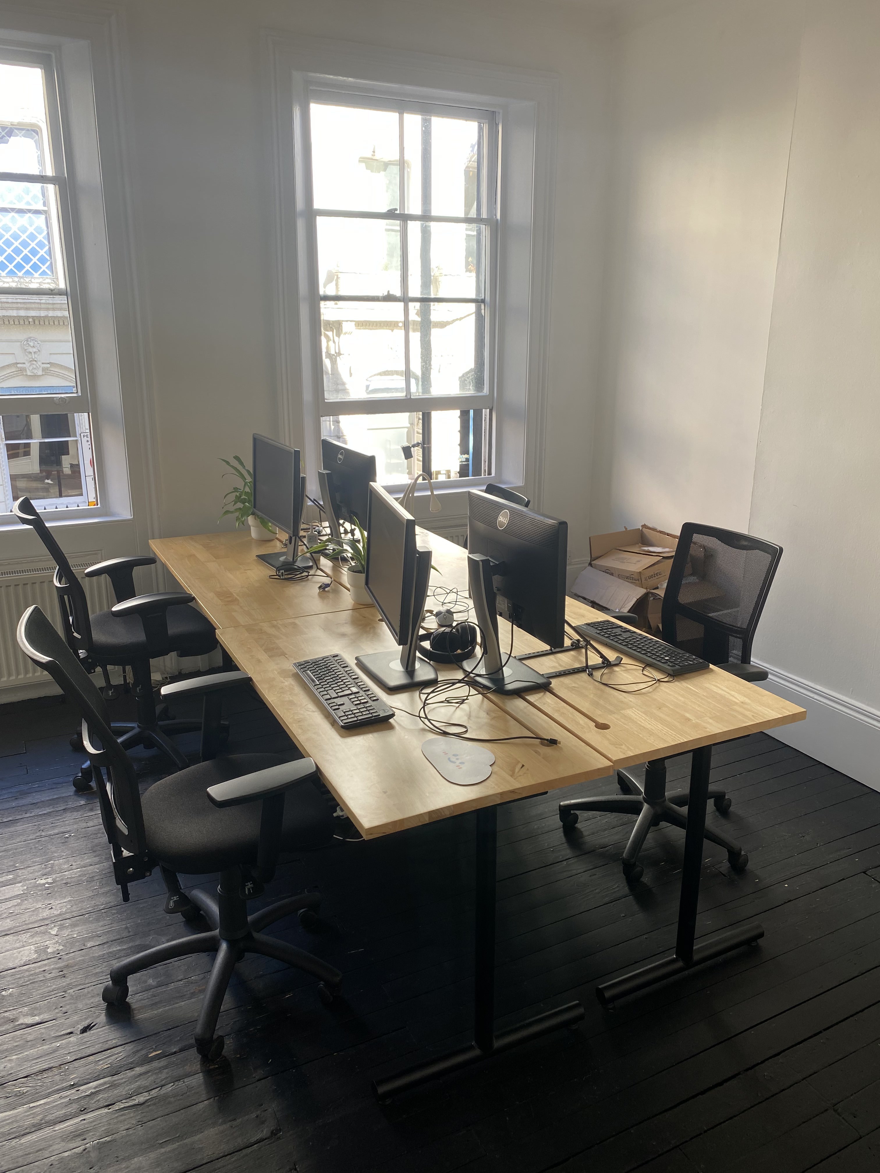 Four desks in shared office with small B-Corp. 