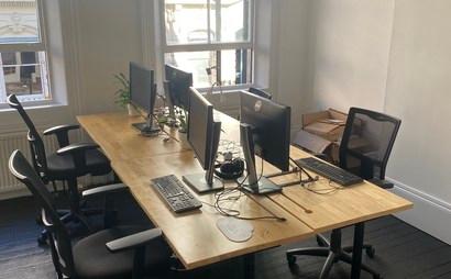 Four desks in shared office with small B-Corp. 