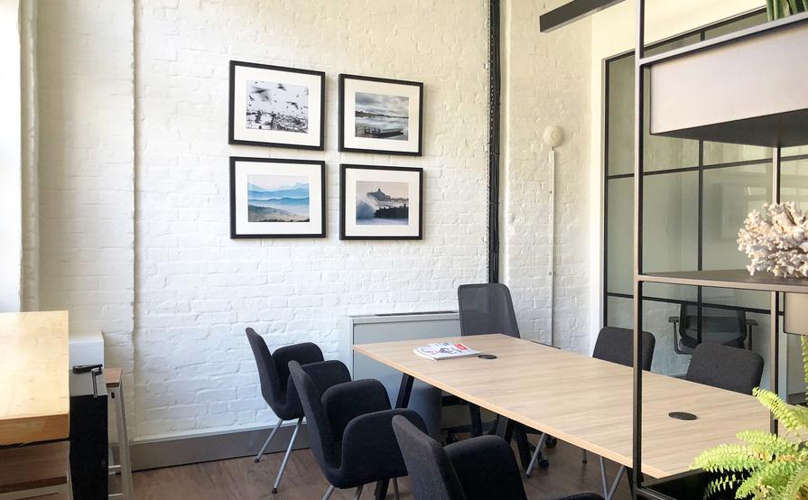 Four desks in a bright, creative warehouse studio in the heart of Queens Park