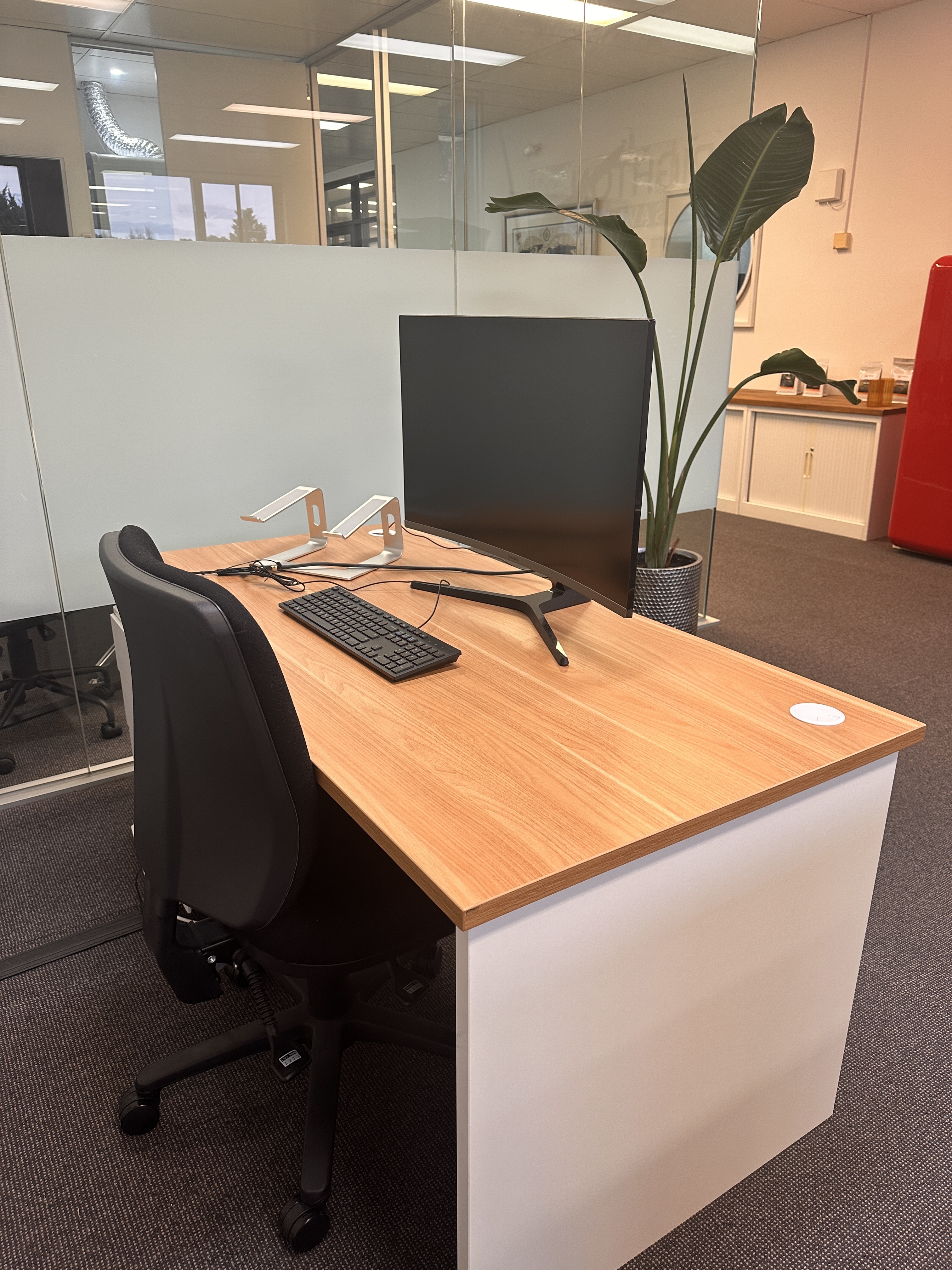Desk in modern office full of marketers who work hard and laugh harder.