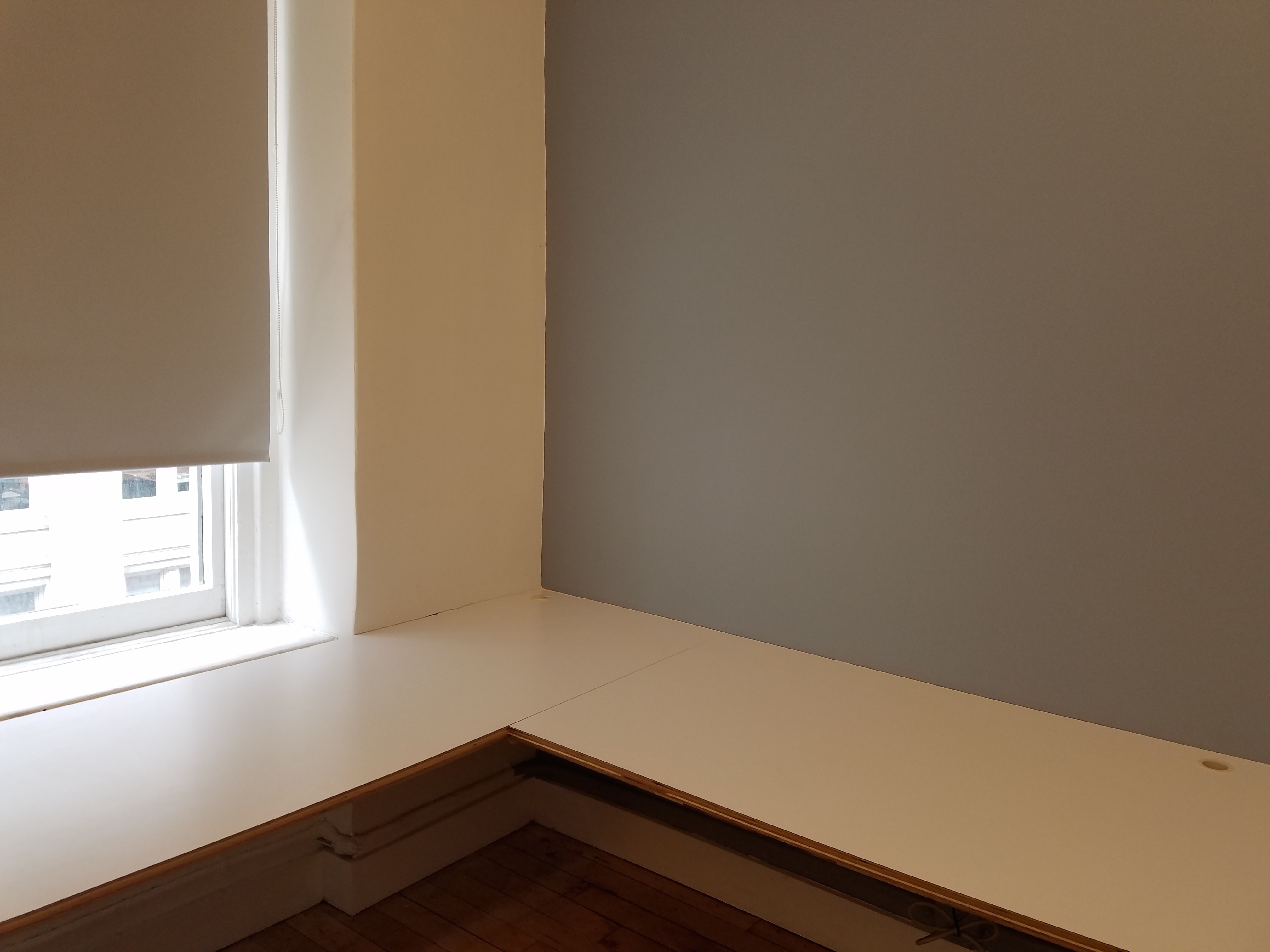 Semi-private corner workspace in quiet creative office