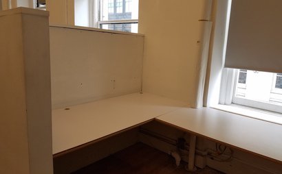 Semi-private corner workspace in quiet creative office