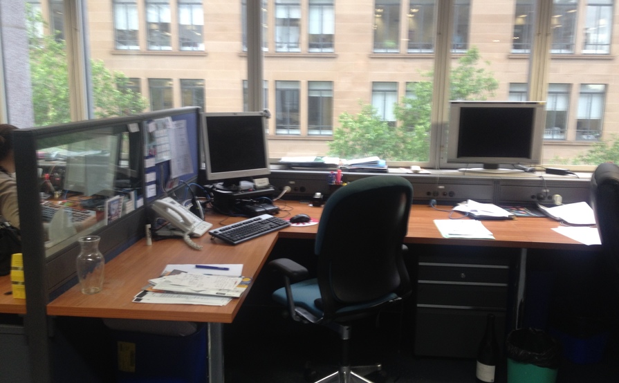 Large desk with plenty of space for storage.