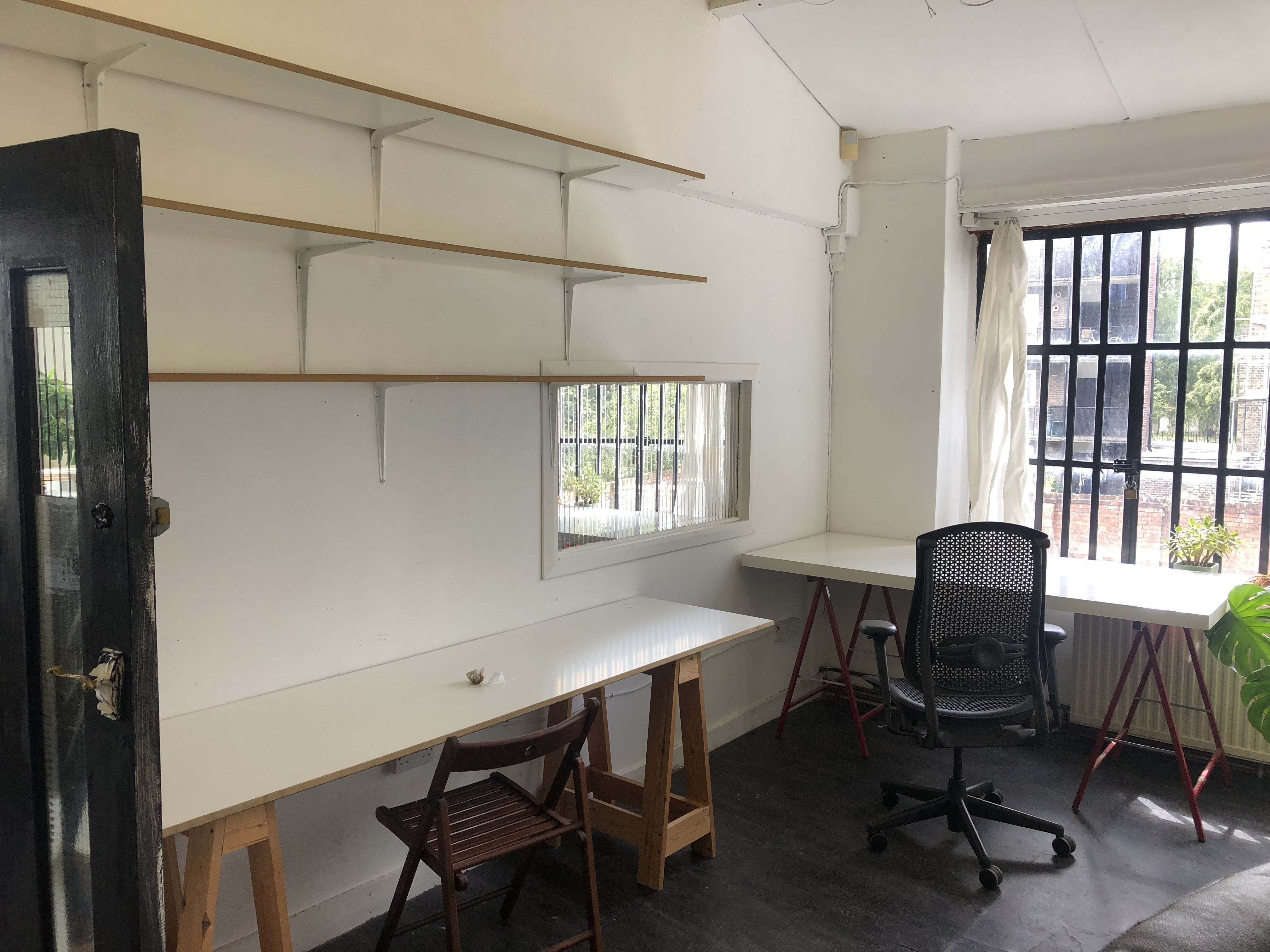 Large desks in a warehose office in Stoke Newington