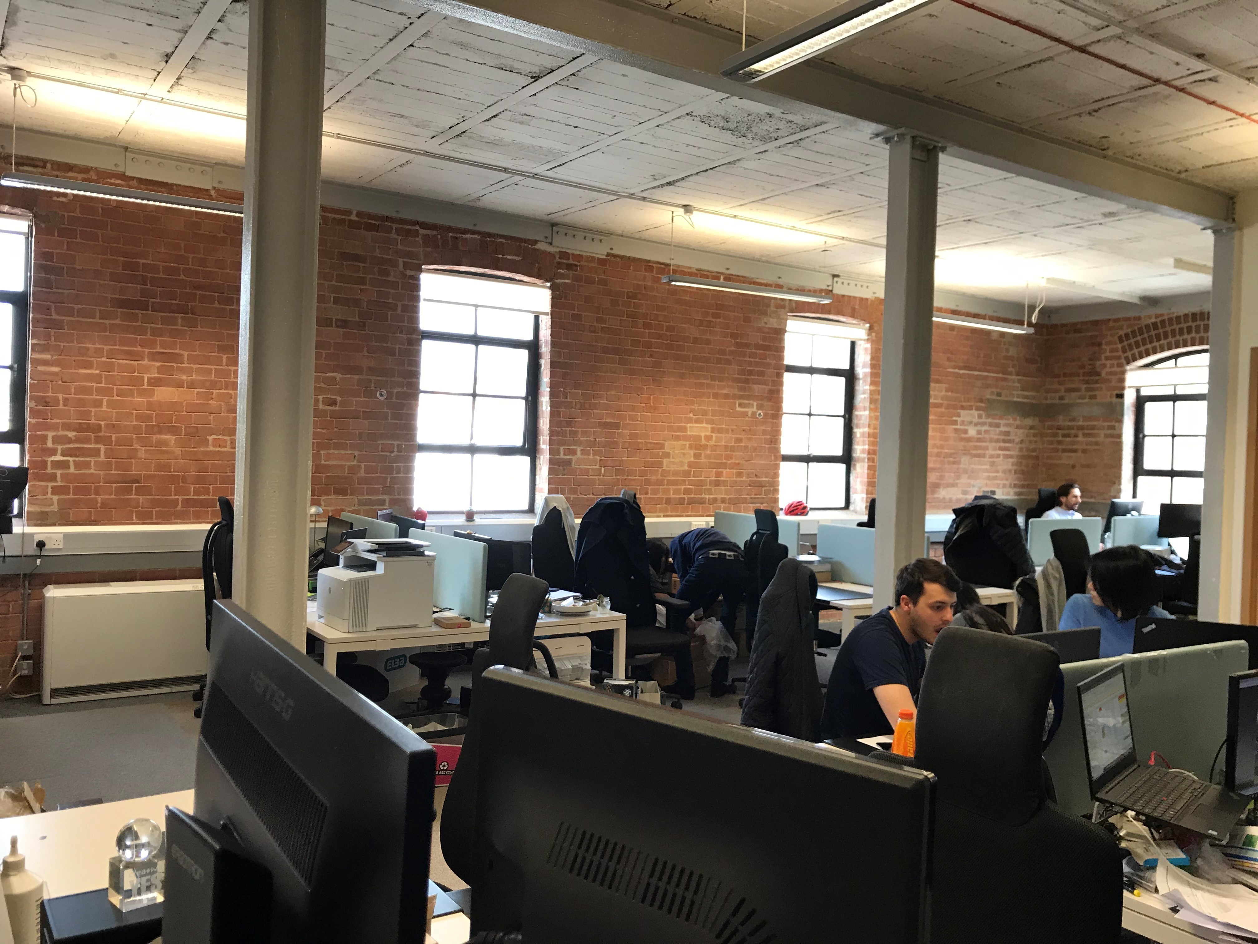 DESKS IN LIGHT AIRY TOP FLOOR WITH HIGH CEILINGS AND LARGE WINDOWS DESKS IN LIGHT AIRY TOP FLOOR WITH HIGH CEILINGS AND LARGE WINDOWS