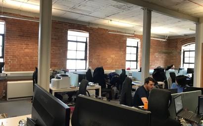 DESKS IN LIGHT AIRY TOP FLOOR WITH HIGH CEILINGS AND LARGE WINDOWS