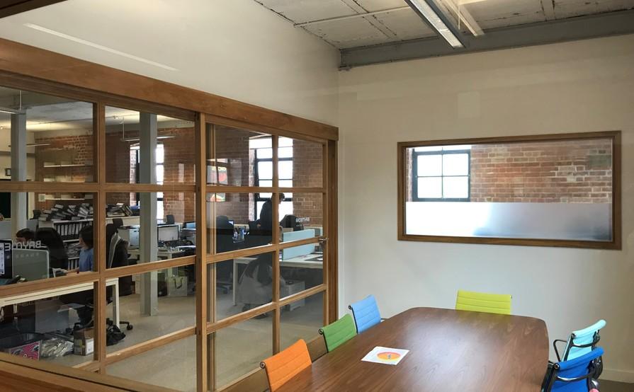 DESKS IN LIGHT AIRY TOP FLOOR WITH HIGH CEILINGS AND LARGE WINDOWS