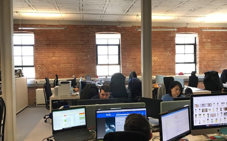 DESKS IN LIGHT AIRY TOP FLOOR WITH HIGH CEILINGS AND LARGE WINDOWS