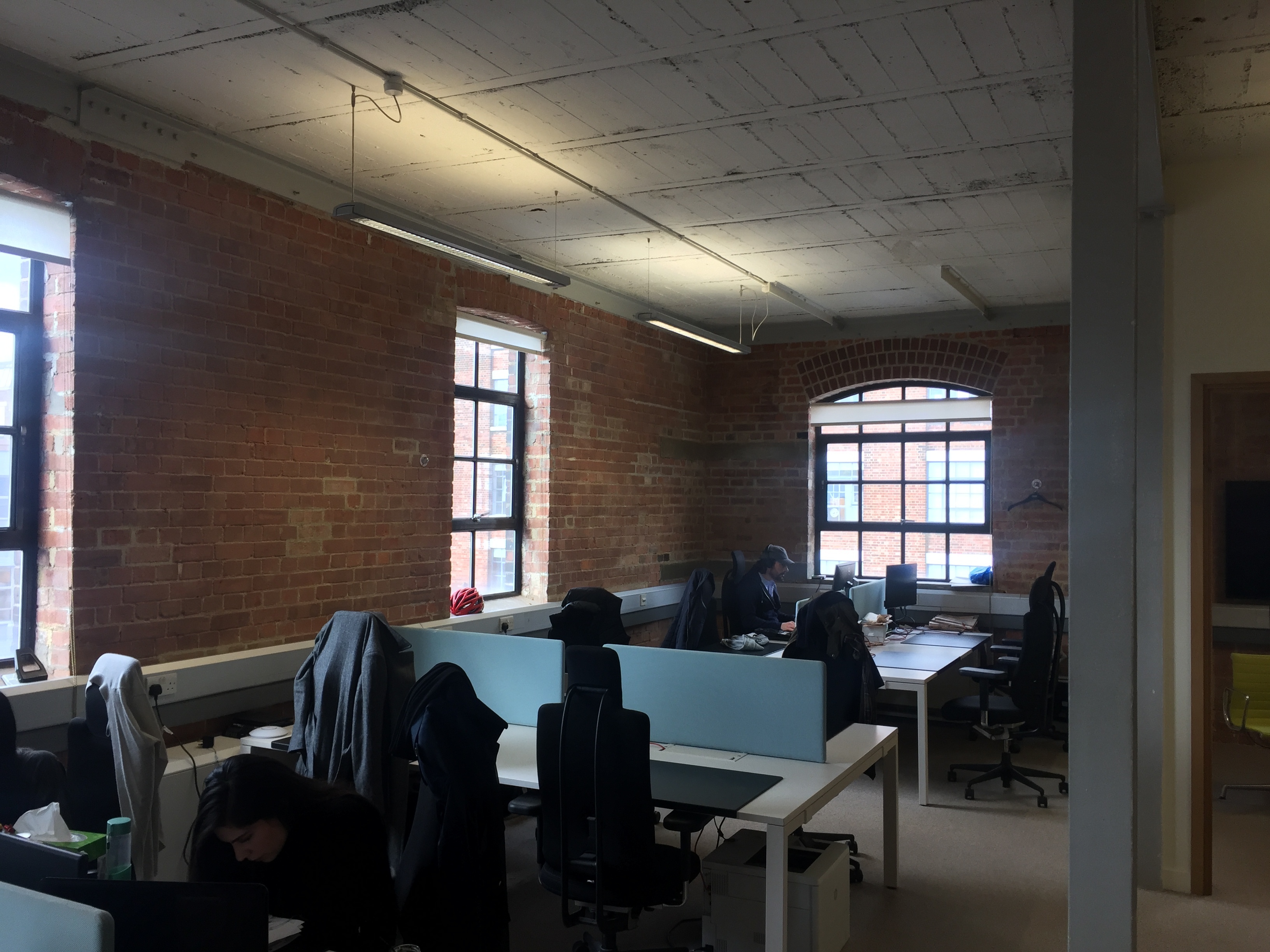 DESKS IN LIGHT AIRY TOP FLOOR WITH HIGH CEILINGS AND LARGE WINDOWS
