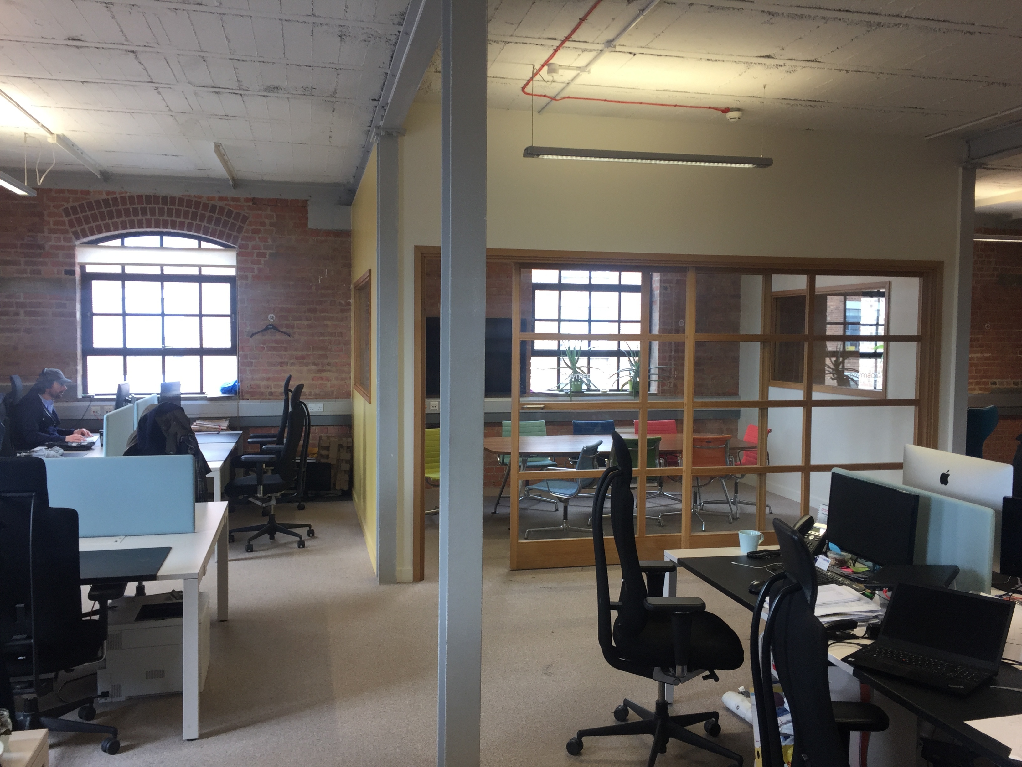 DESKS IN LIGHT AIRY TOP FLOOR WITH HIGH CEILINGS AND LARGE WINDOWS